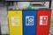 Three waste separation bins for paper, plastic and aluminium with inscription in Italian language and pictograms or pictures for e