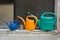 Three watering cans