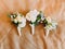 Three wedding mini-bouquets consisted of white roses.
