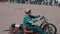 Three-wheeled Moto karting drifts past the crowd of spectators at the motor show. Close-up of a motorcyclist.