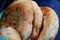 Three white bread buns from tandyr. Tandoor pita Asian cuisine.