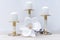 Three white candles on brass candlesticks and a white tropical flower