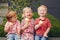 Three white Caucasian cute adorable funny children toddlers sitting together sharing ice-cream