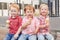 Three white Caucasian cute adorable funny children toddlers sitting together sharing ice-cream