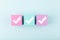 Three white checkmarks on multicolored cubes in a row against bright blue background