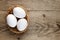 Three white eggs in basket