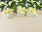 Three white gift boxes with yellow ribbons on beige background.