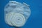 Three white medical plastic colostomy bags