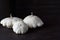 Three white patissons lie on an oak table.