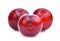 Three whole cherry red plum on white