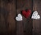 Three wicker small hearts on a brown wooden background