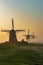 Three wind mills of Molendriegang Leidschendam, Netherlands during a misty Sunrise