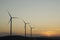 Three wind power aerogenerators skyline at dusk