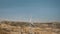 Three wind turbines aerial close up rotate against blue sky. Cinematic drone view of large windmills