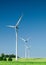 Three wind turbines on green field