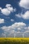 Three Wind Turbines under a blue, cloud-strewn sky