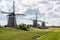Three windmills of `Driemolengang Leidschendam` under a beautiful clouded sky
