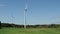 Three windmills spinning slowly on a fall day on farm with cows NY State