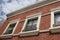 Three windows on brick building