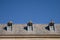 Three windows, roof and blue sky of the Monastery of El Escorial