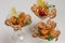 Three wine glasses with shrimp lemon and herbs