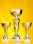 Three winner cup bowl prizes on gold background