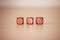 Three woden dices on light beige table
