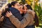 Three woman mother and daughters hugging each other at park