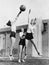 Three women with basketball in the air