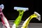 Three women colorful razors with selective focus in a glass beaker on a black background.