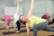 Three women are doing angle pose