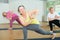 Three women are doing angle pose