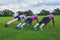 Three women doing push ups in park