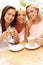 Three Women Enjoying Cup Of Coffee