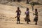 Three women from the Ethiopian tribe Hamer dance at the ceremony Bull Jump.