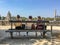 Three women friends sit on Tuileries bench facing Place de la Concorde, Paris, France