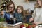 Three women in kitchen preparing Christmas food