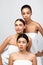 Three Women Posing Wrapped In Towels Over Gray Background, Vertical