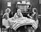 Three women sitting at the dining table talking