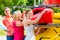 Three women unloading kayak from boat trailer