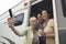 Three women using camera phone in motor home