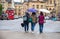 Three women walking away with umbrellas and bags on a rainy day in Oxford England