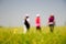 Three women walking in a field, completely out of focus.