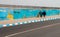 three women walking near the graffiti on the wall, Dakhla, Western Sahara