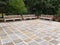 Three wood benches by a patio