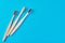 three wooden bamboo toothbrushes on a blue background, top view.  Dental care concept