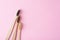 three wooden bamboo toothbrushes on a pink background, top view.  Dental care concept