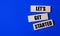 Three wooden blocks with the text LET\\\'S GET STARTED on a bright blue background. Copy space
