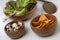 Three wooden bowls with fresh green salad, quail e