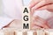 Three wooden cubes with letters AGM - means Absorbent Glass Mat